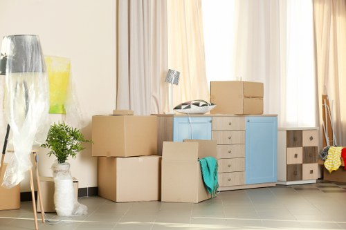 Removal team preparing a London home move with boxes and furniture