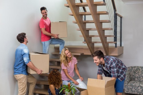 Packed boxes and furniture ready for loading into a moving truck in London