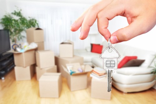 Flat move in London with stairs, boxed belongings, and protective wrapping
