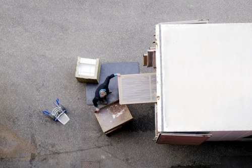 Workers directing reusable household items toward charity and recycling streams