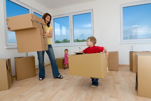Local movers loading household items into a removals van