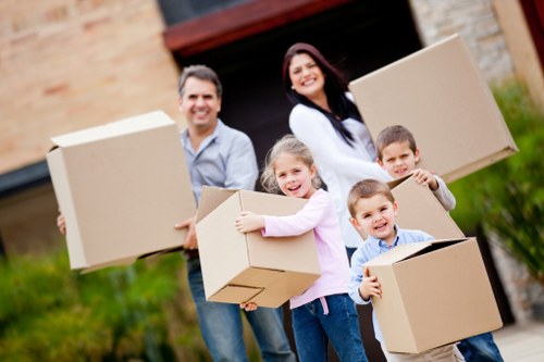 Professional removals team handling furniture in a London flat