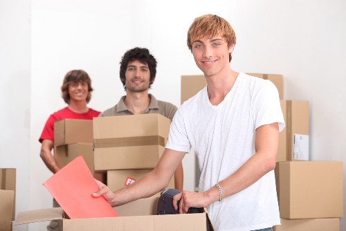 Professional movers handling furniture in a London flat
